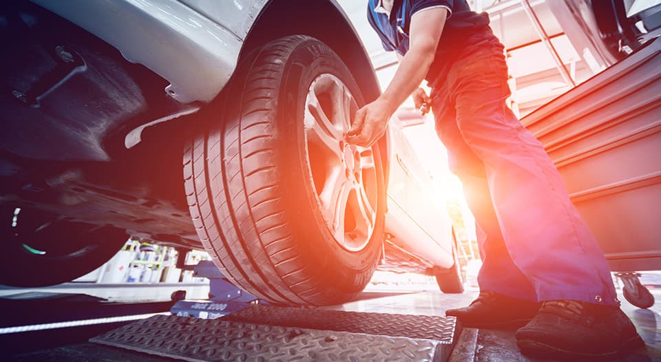 photo of mechanic fixing car tires